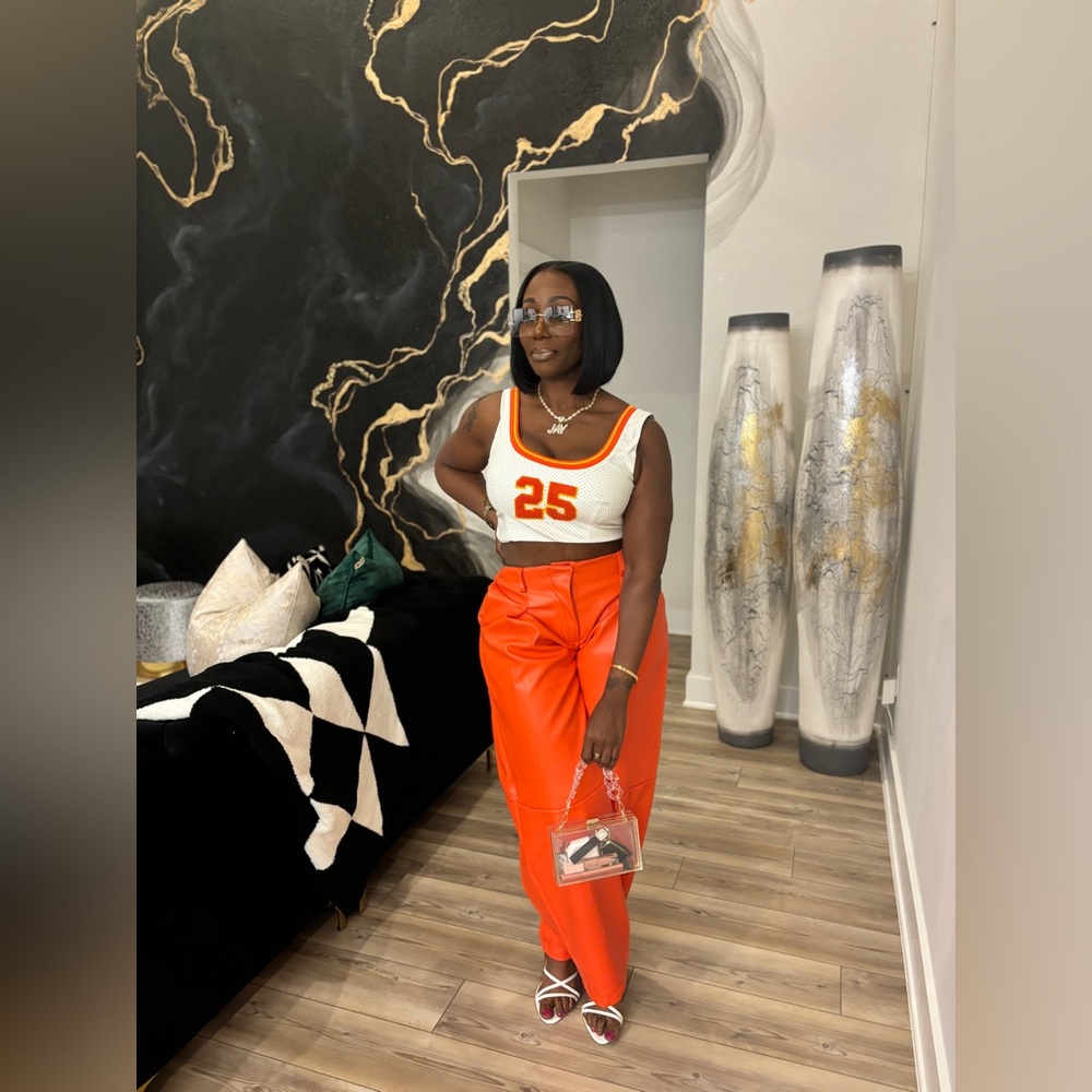 Orange faux leather pants and crop sleeveless faux leather jersey
